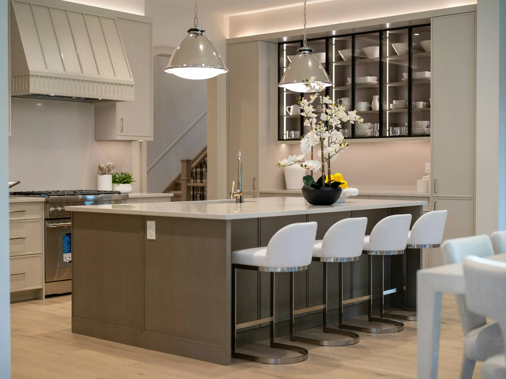 A modern kitchen with pendant lights over the island
